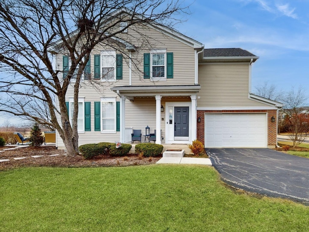 front facade with a garage and a front lawn