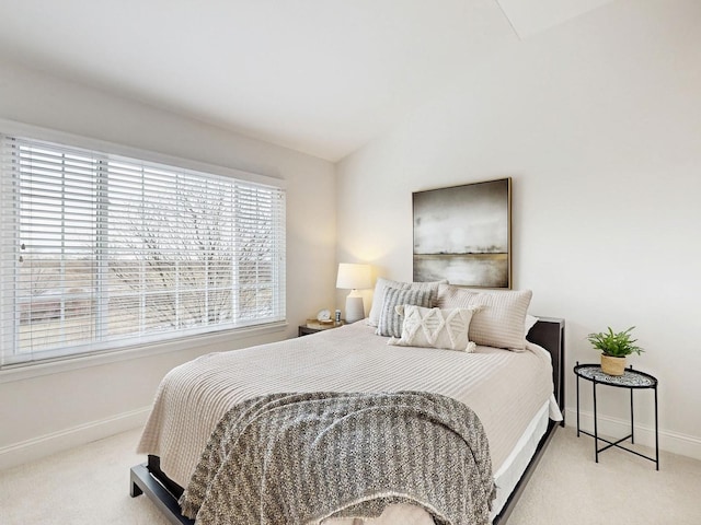 carpeted bedroom featuring lofted ceiling