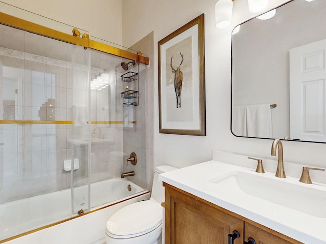 full bathroom with toilet, vanity, and bath / shower combo with glass door