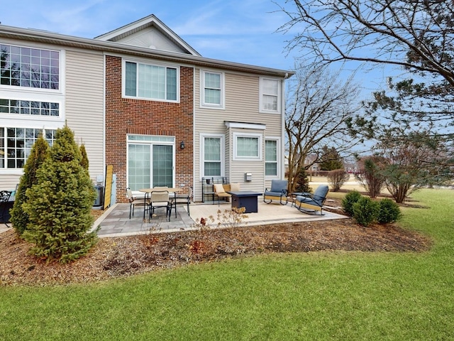 rear view of property featuring a lawn and a patio