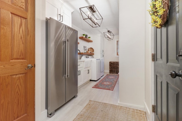 interior space featuring hardwood / wood-style flooring and washing machine and clothes dryer