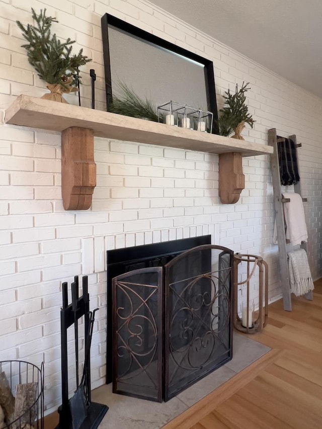 interior details with a fireplace and wood-type flooring