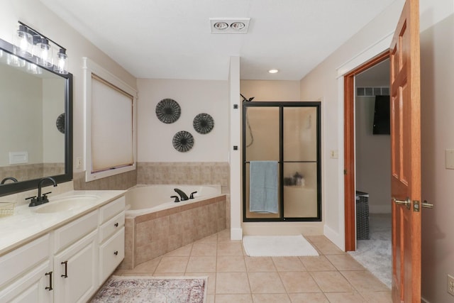 bathroom featuring vanity, independent shower and bath, and tile patterned flooring