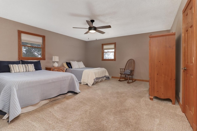 bedroom featuring ceiling fan and light colored carpet