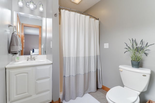 bathroom featuring toilet, vanity, a shower with curtain, and tile patterned flooring