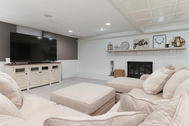 living room featuring a fireplace and light carpet