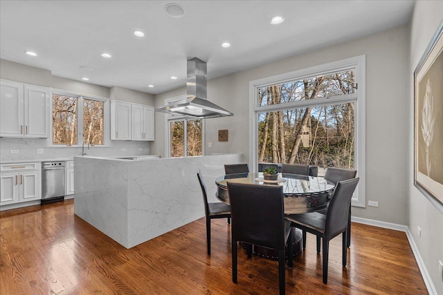 dining space with wood-type flooring