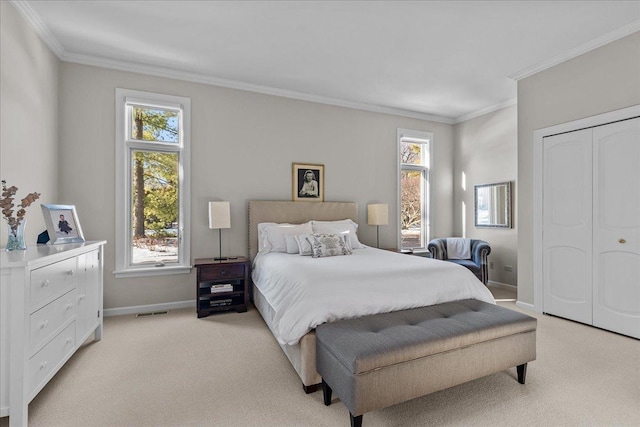 bedroom with crown molding, light colored carpet, and multiple windows