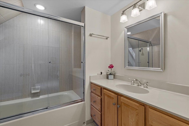 bathroom with vanity and shower / bath combination with glass door