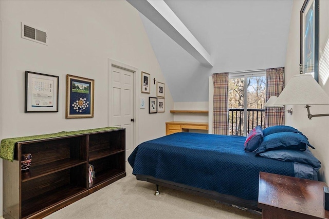 carpeted bedroom featuring lofted ceiling