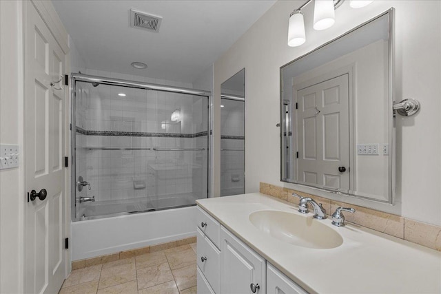 bathroom featuring vanity and combined bath / shower with glass door