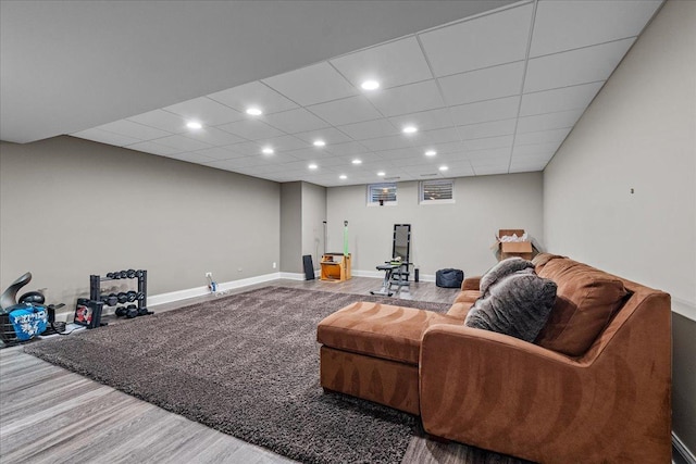 living room with a paneled ceiling and wood-type flooring