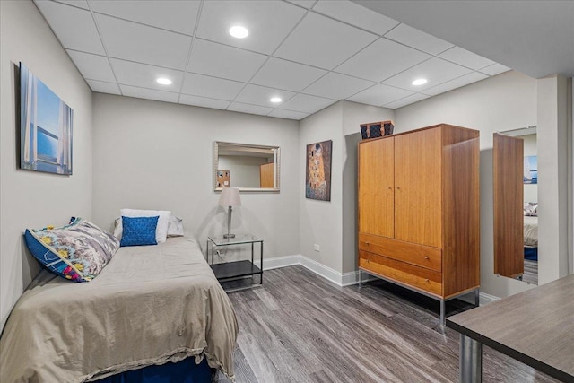 bedroom featuring dark hardwood / wood-style floors and a drop ceiling