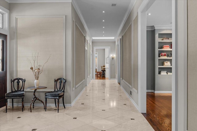 corridor with light tile patterned floors and ornamental molding