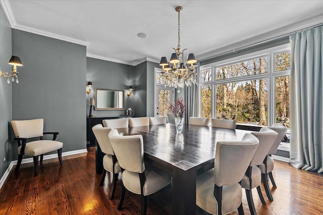 dining room with ornamental molding, dark wood-type flooring, and a notable chandelier