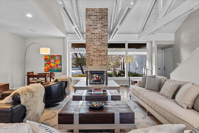 living room with beam ceiling, a healthy amount of sunlight, and a multi sided fireplace