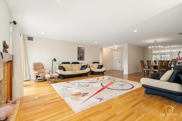 living room with a chandelier and hardwood / wood-style floors