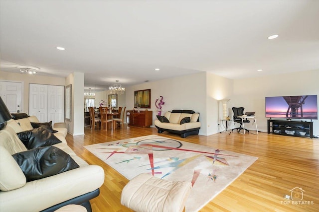 living room featuring hardwood / wood-style floors and an inviting chandelier