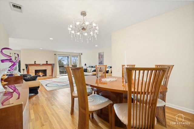 dining room with an inviting chandelier and light wood-type flooring