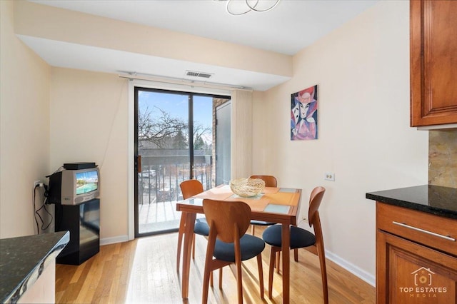 dining space with light wood-type flooring