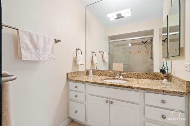 bathroom with vanity and an enclosed shower