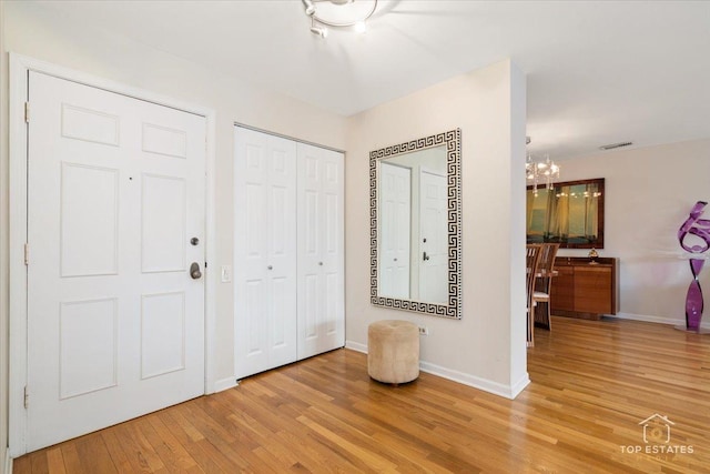 interior space featuring an inviting chandelier and hardwood / wood-style flooring