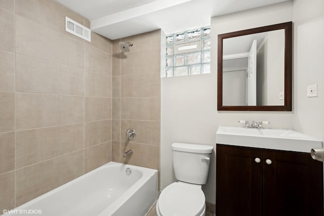 full bathroom featuring toilet, vanity, and tiled shower / bath combo