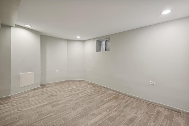 basement with light hardwood / wood-style floors