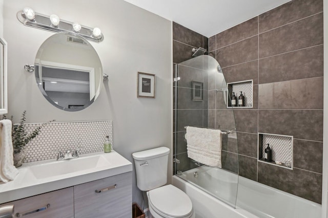 full bathroom with enclosed tub / shower combo, vanity, backsplash, and toilet