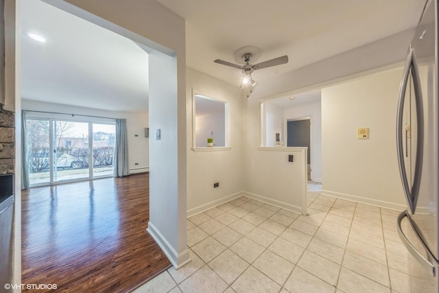 tiled empty room featuring ceiling fan