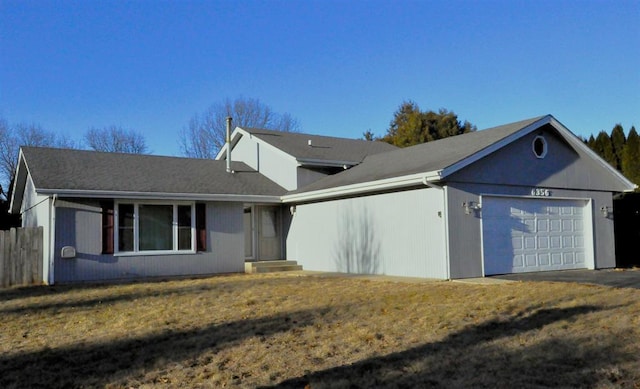 ranch-style house featuring a garage and a front yard