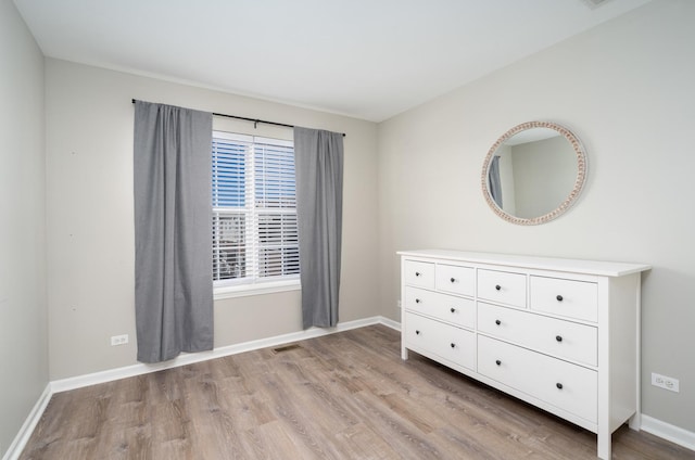 unfurnished bedroom with light wood-type flooring