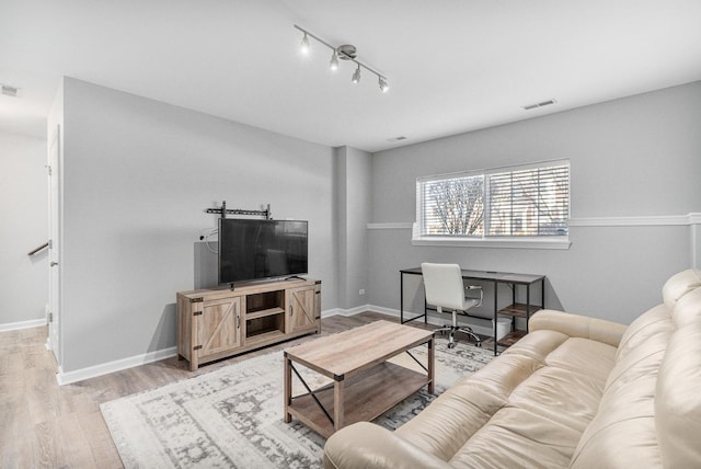 living room featuring track lighting and light hardwood / wood-style floors