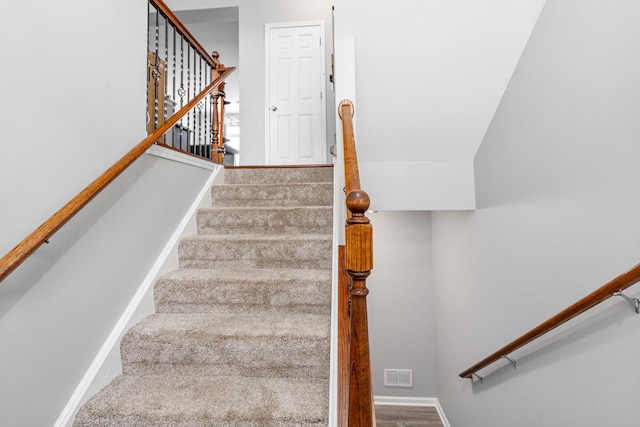 staircase with vaulted ceiling