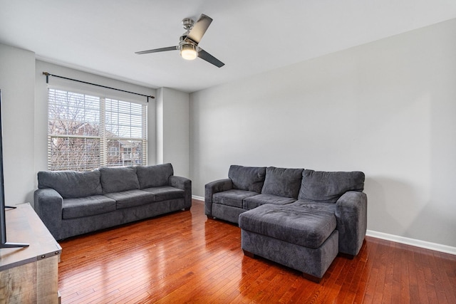 living room with dark hardwood / wood-style floors and ceiling fan