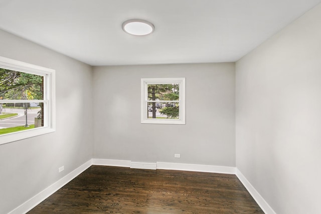 spare room with dark hardwood / wood-style floors