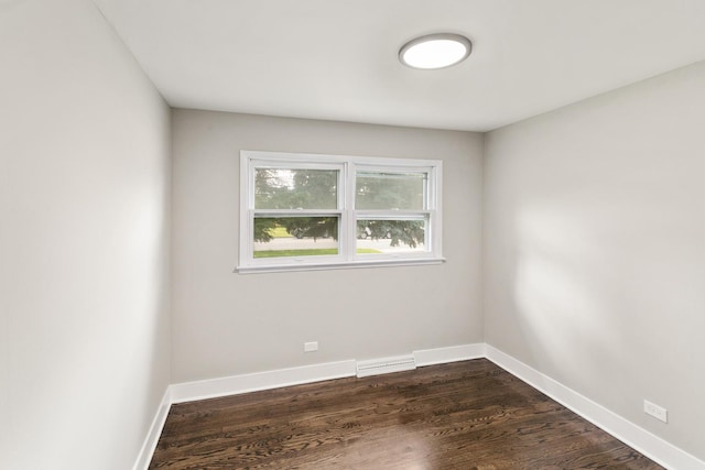 spare room featuring dark wood-type flooring