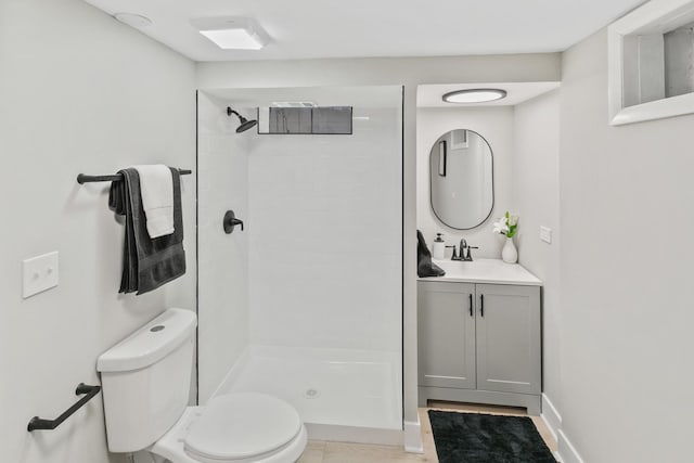 bathroom with toilet, walk in shower, and vanity