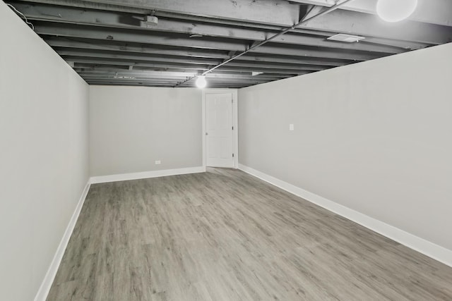 basement with hardwood / wood-style floors