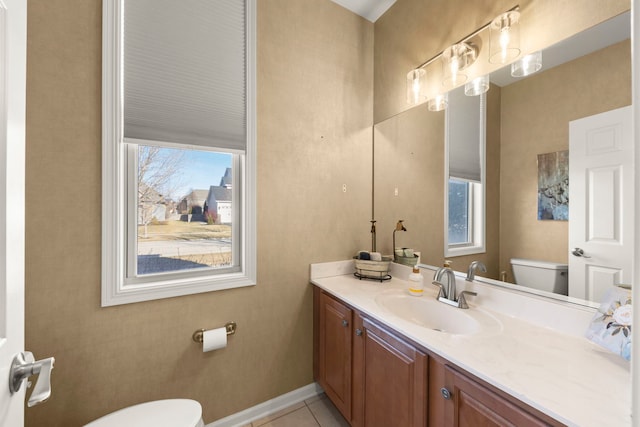 bathroom featuring tile patterned flooring, vanity, and toilet