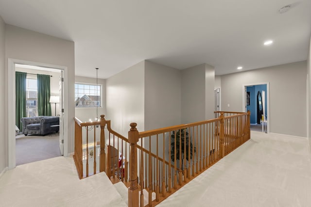 hallway with light colored carpet