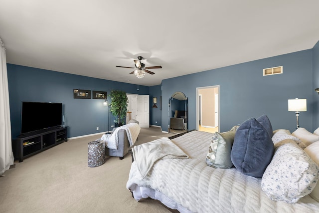 bedroom featuring light carpet and ceiling fan