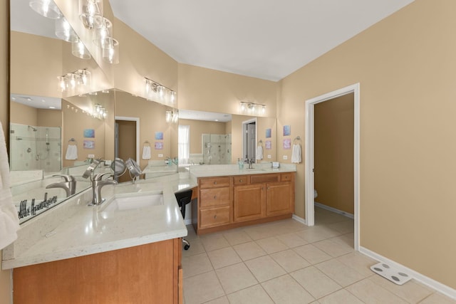 bathroom with a shower with door, vanity, tile patterned floors, and toilet