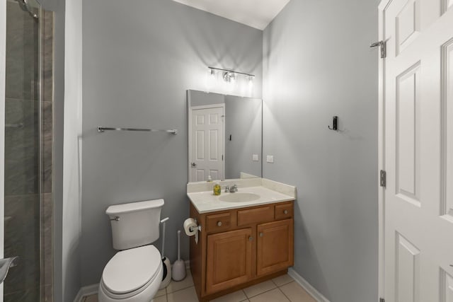 bathroom with vanity, tile patterned floors, and toilet