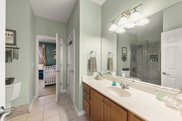 bathroom with vanity, toilet, tile patterned flooring, and a shower with door