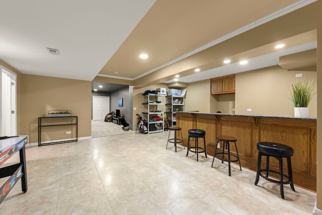 bar featuring crown molding and dark stone counters