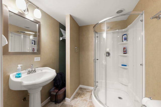 bathroom with walk in shower and tile patterned flooring