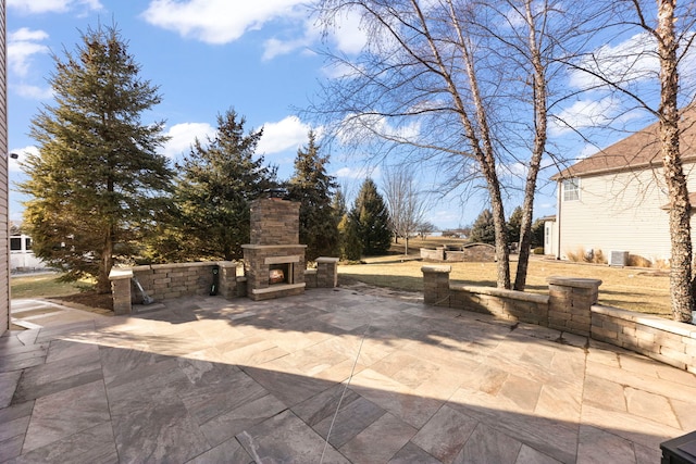 view of patio / terrace with an outdoor stone fireplace