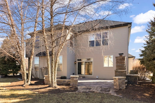 back of property with a patio