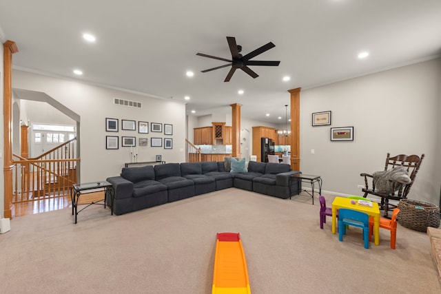 living room with light carpet, crown molding, ceiling fan, and ornate columns